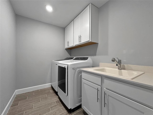 6256 Baywood Ct, Bradenton, FL 34211 - laundry area featuring washing machine and dryer, wood finish floors, cabinet space, and recessed lighting