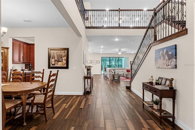 13525 Gorgona Isle Dr, Windermere, FL 34786 - dining space with dark wood-style floors, stairway, a ceiling fan, and a high ceiling