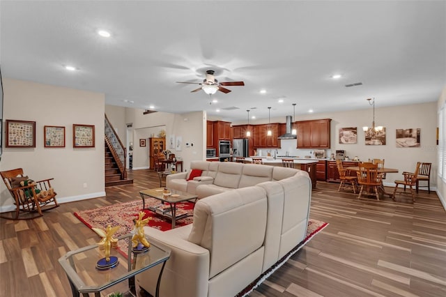 13525 Gorgona Isle Dr, Windermere, FL 34786 - living room with recessed lighting, dark wood-style flooring, a ceiling fan, stairway, and a chandelier