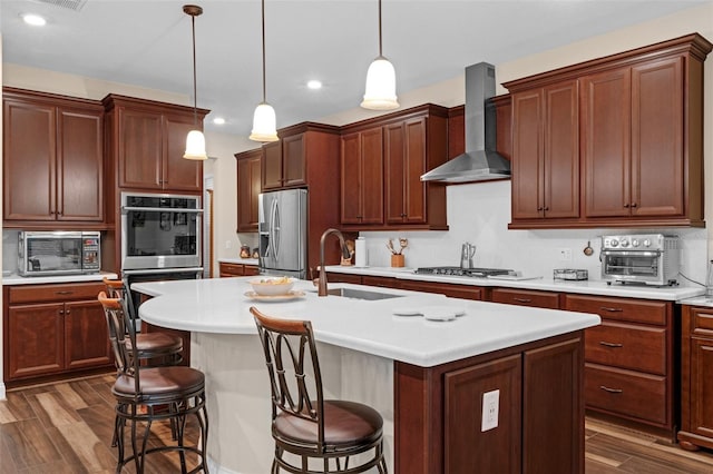 13525 Gorgona Isle Dr, Windermere, FL 34786 - kitchen with appliances with stainless steel finishes, wall chimney exhaust hood, dark wood-style flooring, a breakfast bar area, and recessed lighting
