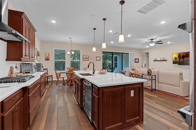 13525 Gorgona Isle Dr, Windermere, FL 34786 - kitchen featuring wall chimney range hood, stainless steel appliances, dark wood-style flooring, light countertops, and recessed lighting