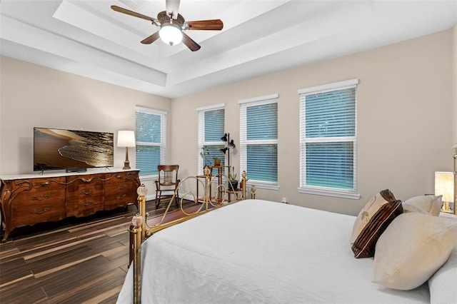 13525 Gorgona Isle Dr, Windermere, FL 34786 - bedroom featuring wood finished floors, a tray ceiling, and ceiling fan