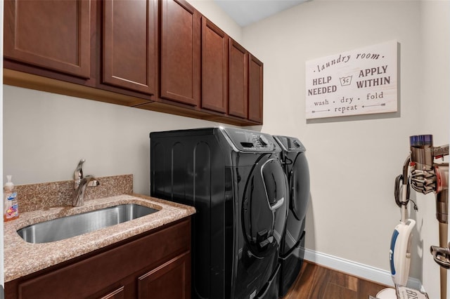 13525 Gorgona Isle Dr, Windermere, FL 34786 - washroom with washing machine and clothes dryer, cabinet space, and dark wood finished floors