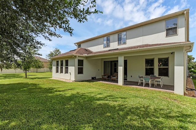 13525 Gorgona Isle Dr, Windermere, FL 34786 - rear view of house featuring stucco siding, a patio area, and a lawn