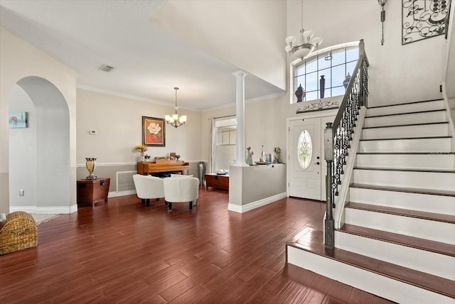 13147 Meergate Cir, Orlando, FL 32837 - entryway featuring a chandelier, stairs, arched walkways, wood finished floors, and ornamental molding