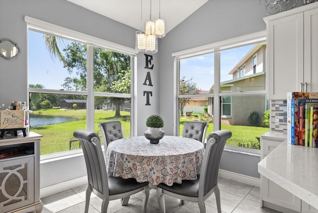 13147 Meergate Cir, Orlando, FL 32837 - dining space featuring a water view, plenty of natural light, a chandelier, vaulted ceiling, and light tile patterned flooring