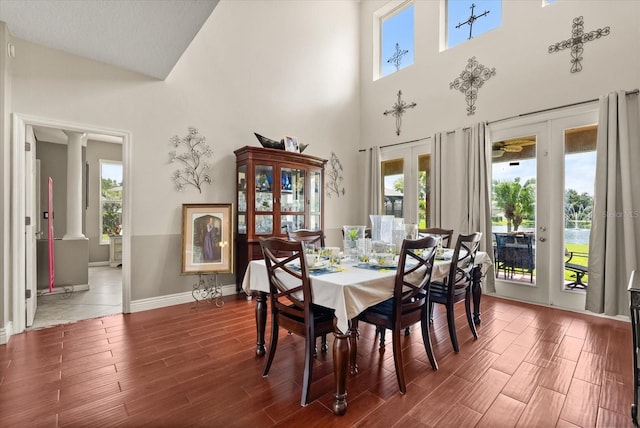 13147 Meergate Cir, Orlando, FL 32837 - dining area with ornate columns, wood finished floors, a towering ceiling, and french doors