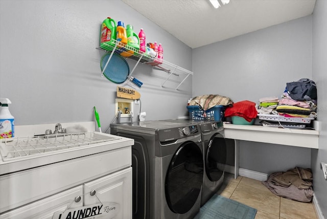 13147 Meergate Cir, Orlando, FL 32837 - laundry room featuring washer and clothes dryer, light tile patterned floors, and cabinet space