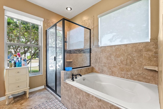 13147 Meergate Cir, Orlando, FL 32837 - bathroom with healthy amount of natural light, a stall shower, a garden tub, and tile patterned floors