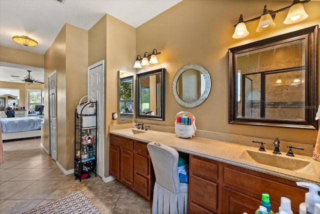 13147 Meergate Cir, Orlando, FL 32837 - ensuite bathroom featuring ceiling fan, double vanity, tile patterned flooring, and a tile shower
