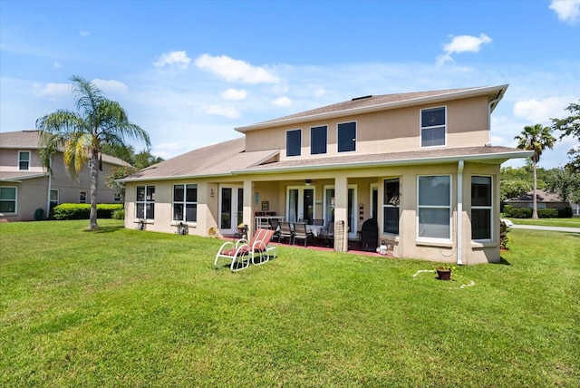13147 Meergate Cir, Orlando, FL 32837 - back of house featuring ceiling fan, stucco siding, a yard, and a patio