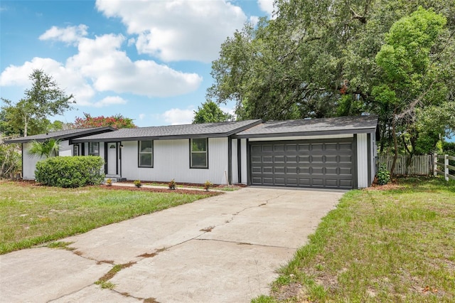 18015 Beach St, Umatilla, FL 32784 - view of front of house featuring concrete driveway and a garage