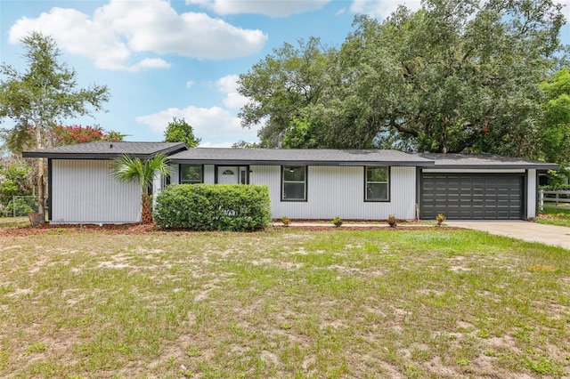 18015 Beach St, Umatilla, FL 32784 - single story home with a front lawn, a garage, and concrete driveway