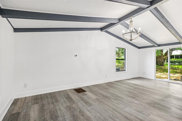 18015 Beach St, Umatilla, FL 32784 - spare room with a chandelier, healthy amount of natural light, and wood finished floors