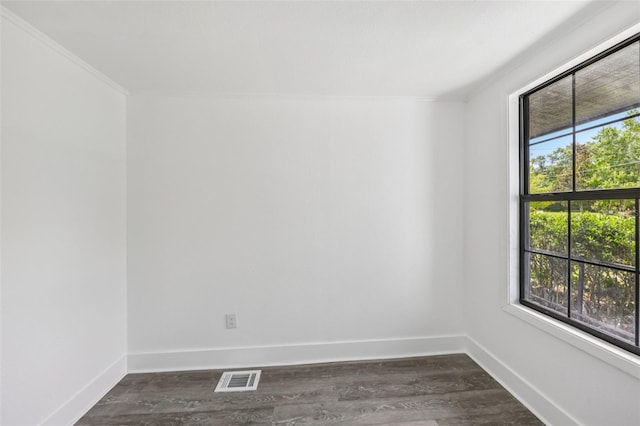18015 Beach St, Umatilla, FL 32784 - empty room with ornamental molding and dark wood-type flooring