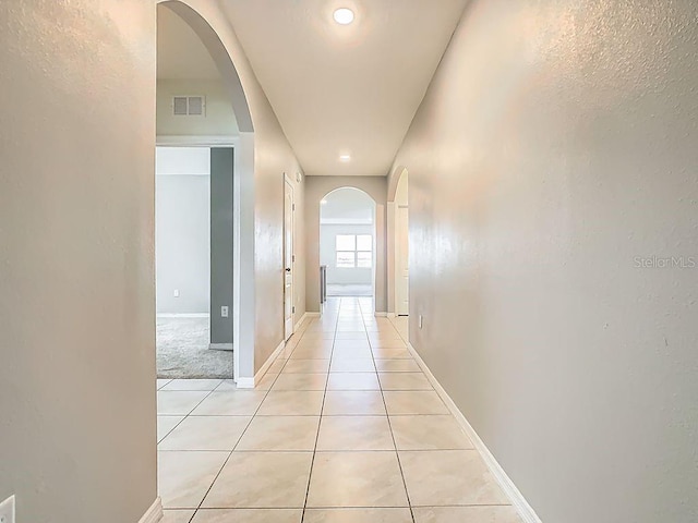 313 Sofia Ln, Lake Alfred, FL 33850 - hall featuring arched walkways, light tile patterned floors, and recessed lighting