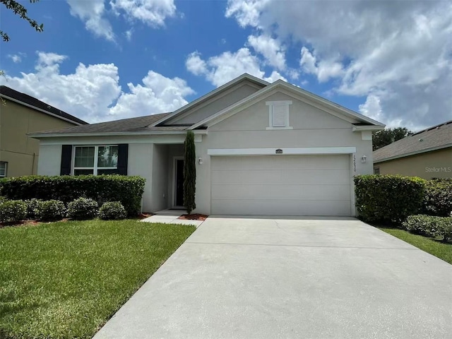 12630 Old Plantation Ln, Orlando, FL 32824 - ranch-style home with stucco siding, an attached garage, driveway, and a front lawn