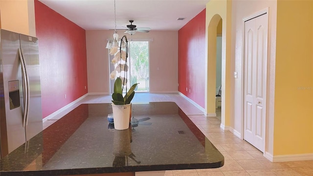 12630 Old Plantation Ln, Orlando, FL 32824 - unfurnished dining area featuring arched walkways, ceiling fan, and light tile patterned floors