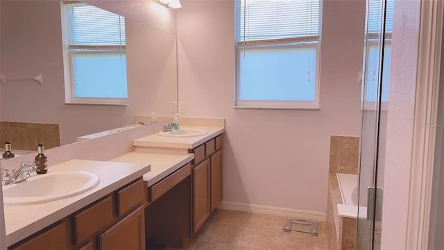 12630 Old Plantation Ln, Orlando, FL 32824 - bathroom featuring healthy amount of natural light, double vanity, tile patterned flooring, and a tub to relax in