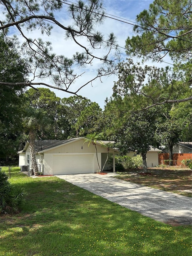 9504 W Cluster Ave, Tampa, FL 33615 - view of front of home with driveway and an attached garage