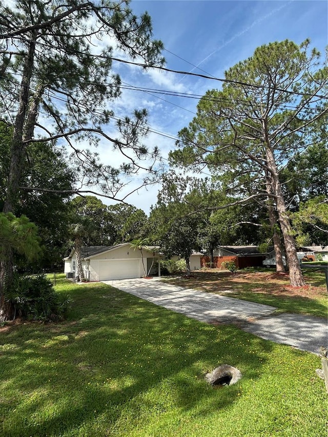 9504 W Cluster Ave, Tampa, FL 33615 - obstructed view of property with driveway, a front lawn, and an attached garage