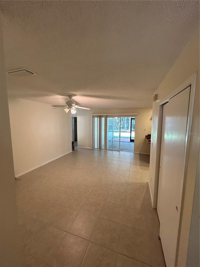 9504 W Cluster Ave, Tampa, FL 33615 - empty room featuring a textured ceiling and a ceiling fan