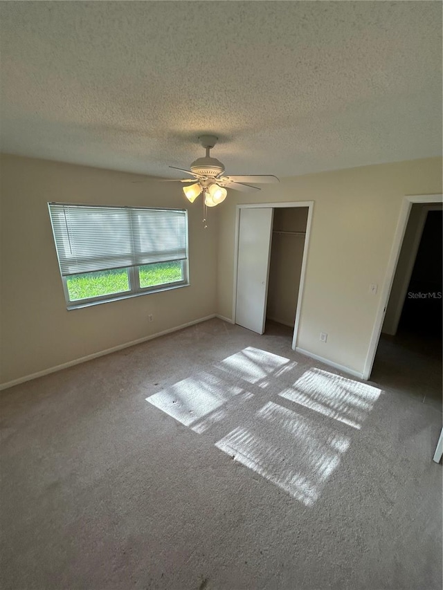 9504 W Cluster Ave, Tampa, FL 33615 - unfurnished bedroom featuring a textured ceiling, carpet, a closet, and a ceiling fan