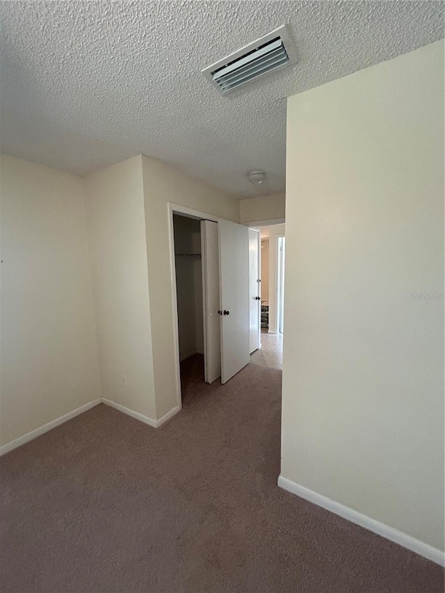 9504 W Cluster Ave, Tampa, FL 33615 - corridor with carpet and a textured ceiling
