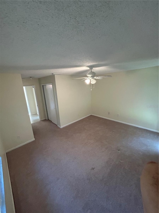 9504 W Cluster Ave, Tampa, FL 33615 - spare room featuring a ceiling fan, carpet, and a textured ceiling