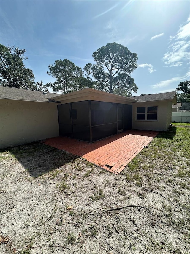 9504 W Cluster Ave, Tampa, FL 33615 - rear view of house featuring a patio area, stucco siding, and a sunroom