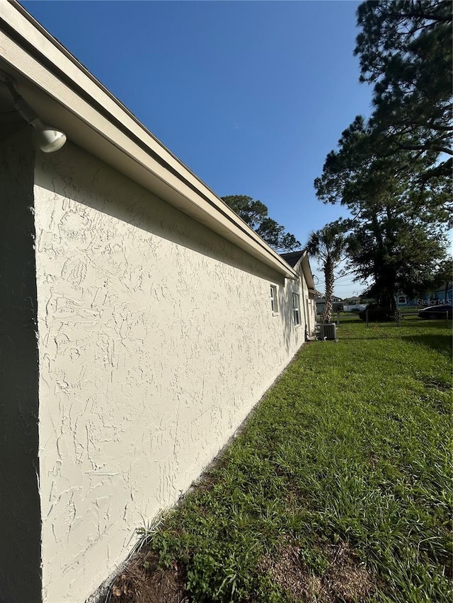 9504 W Cluster Ave, Tampa, FL 33615 - view of property exterior with stucco siding and a yard