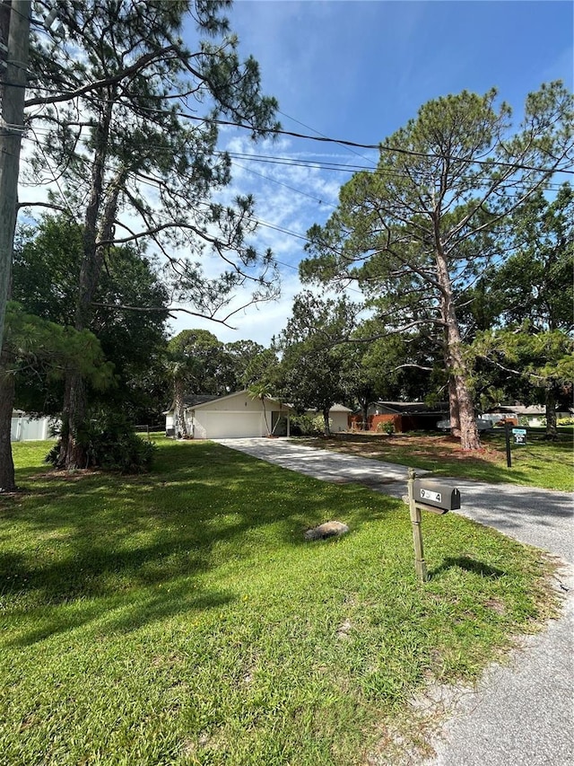9504 W Cluster Ave, Tampa, FL 33615 - obstructed view of property featuring driveway and a front yard