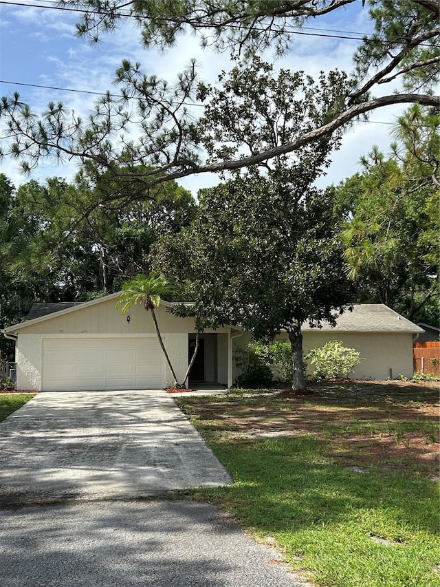 9504 W Cluster Ave, Tampa, FL 33615 - obstructed view of property with concrete driveway and a garage