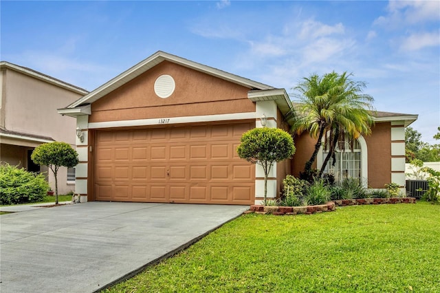 13217 Briar Forest Ct, Orlando, FL 32828 - view of front of house featuring an attached garage, stucco siding, concrete driveway, and a front lawn