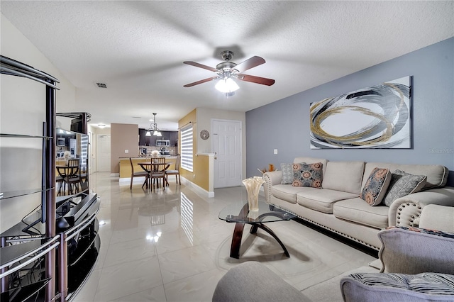 13217 Briar Forest Ct, Orlando, FL 32828 - living area featuring a ceiling fan and a textured ceiling