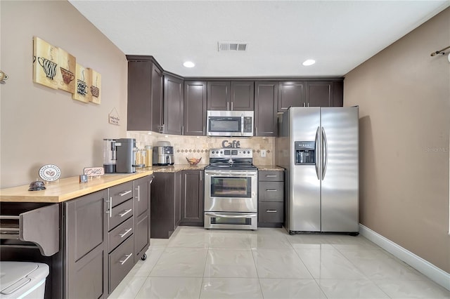 13217 Briar Forest Ct, Orlando, FL 32828 - kitchen featuring stainless steel appliances, light marble finish flooring, backsplash, light stone counters, and recessed lighting