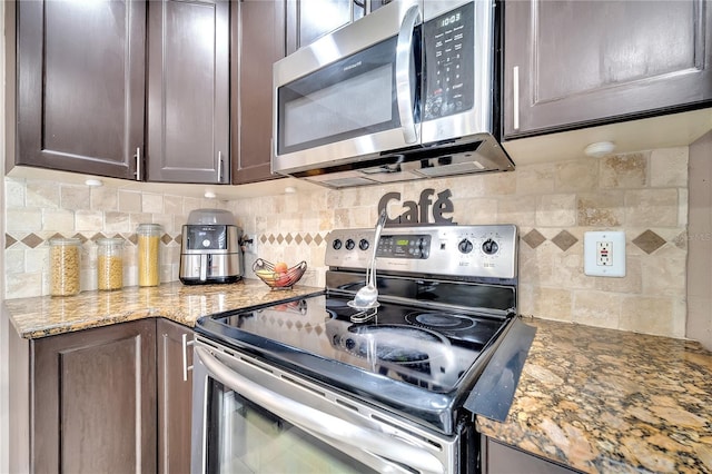 13217 Briar Forest Ct, Orlando, FL 32828 - kitchen featuring appliances with stainless steel finishes, tasteful backsplash, dark brown cabinets, and light stone counters