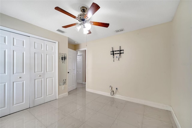 13217 Briar Forest Ct, Orlando, FL 32828 - unfurnished bedroom featuring a closet, light marble finish floors, and a ceiling fan