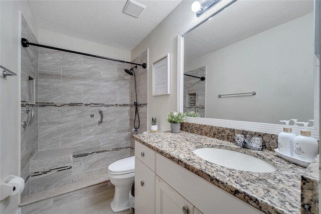 13217 Briar Forest Ct, Orlando, FL 32828 - bathroom with vanity, tiled shower, and a textured ceiling