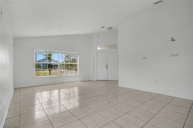118 Sir Phillips Dr, Davenport, FL 33837 - spare room featuring vaulted ceiling and light tile patterned floors