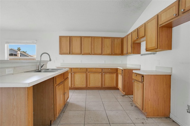 118 Sir Phillips Dr, Davenport, FL 33837 - kitchen with vaulted ceiling, light countertops, light tile patterned floors, and brown cabinetry