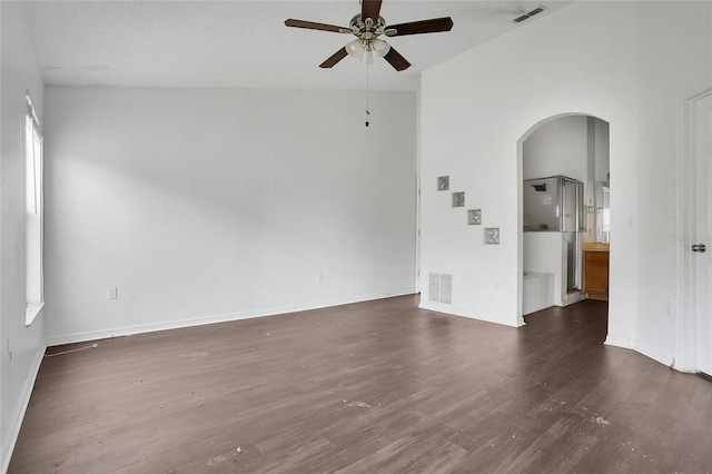 118 Sir Phillips Dr, Davenport, FL 33837 - empty room featuring arched walkways, a ceiling fan, and dark wood-style flooring