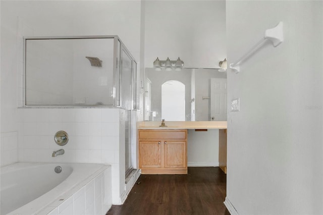 118 Sir Phillips Dr, Davenport, FL 33837 - bathroom featuring a stall shower, vanity, a bath, and wood finished floors