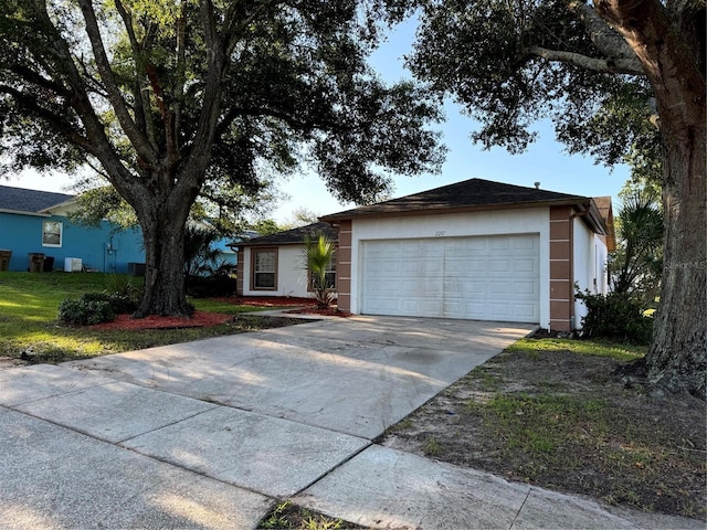 2207 Robel Trl, Clermont, FL 34714 - ranch-style home featuring stucco siding, driveway, and an attached garage