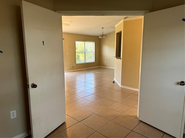 2207 Robel Trl, Clermont, FL 34714 - unfurnished room with light tile patterned flooring, a chandelier, and a textured ceiling