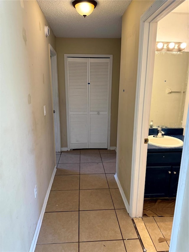 2207 Robel Trl, Clermont, FL 34714 - corridor featuring a textured ceiling and light tile patterned flooring