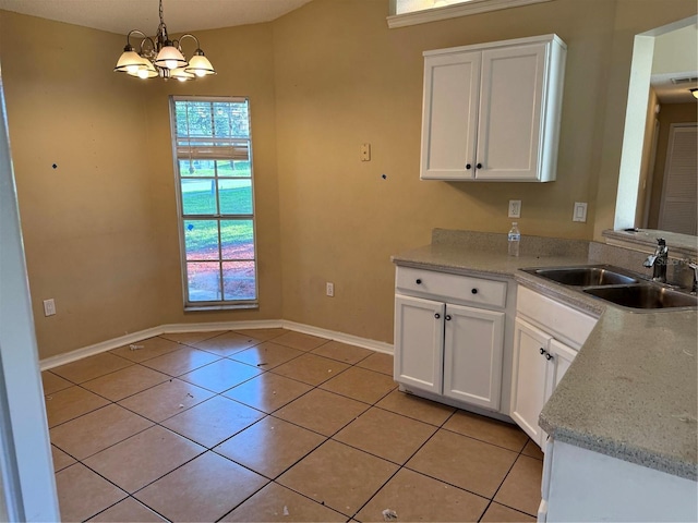 2207 Robel Trl, Clermont, FL 34714 - kitchen with a chandelier, white cabinets, light tile patterned floors, and pendant lighting