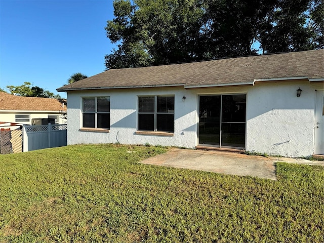 2207 Robel Trl, Clermont, FL 34714 - back of house with stucco siding and a shingled roof