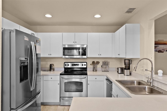 141 Winsor Ave, Davenport, FL 33837 - kitchen with stainless steel appliances, a peninsula, light countertops, and recessed lighting