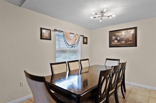 141 Winsor Ave, Davenport, FL 33837 - dining room with a chandelier, light tile patterned floors, a textured ceiling, and a textured wall